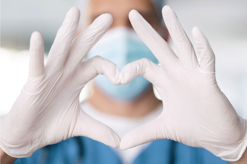 Surgeon holding hands in heart shape